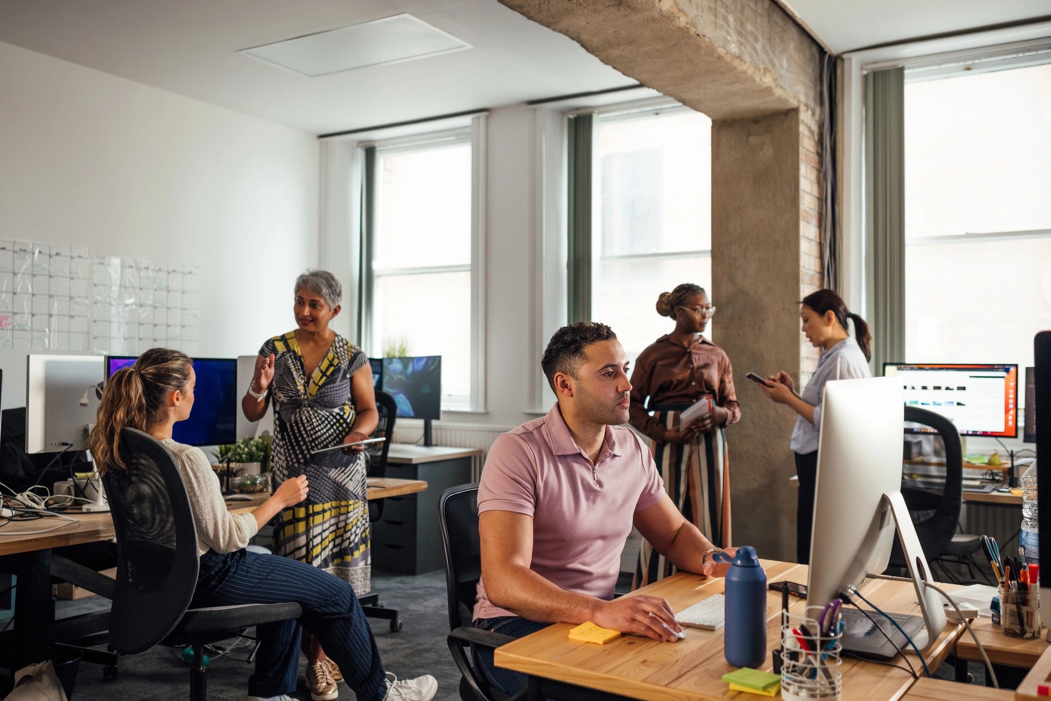 Collaborative IT team working in an office